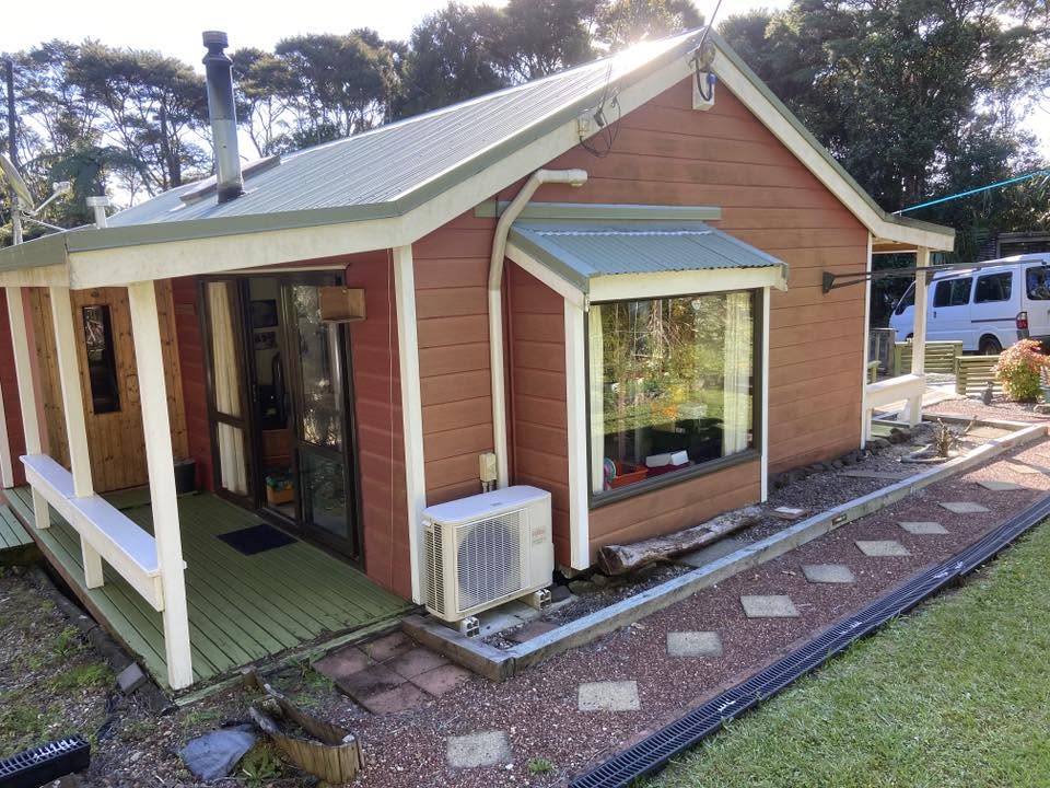 Freshly painted terracotta weatherboard cottage exterior
