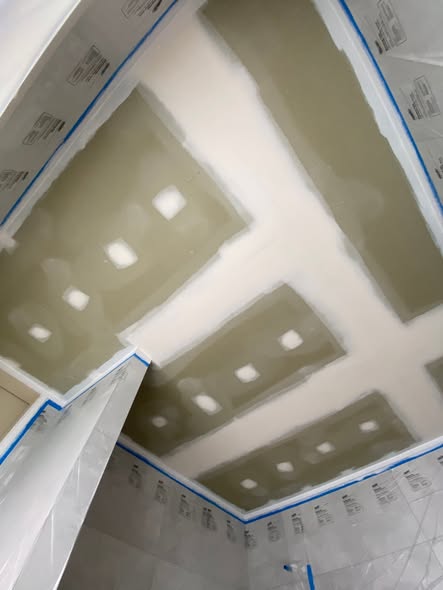 Interior ceiling and walls masked and prepped for painting